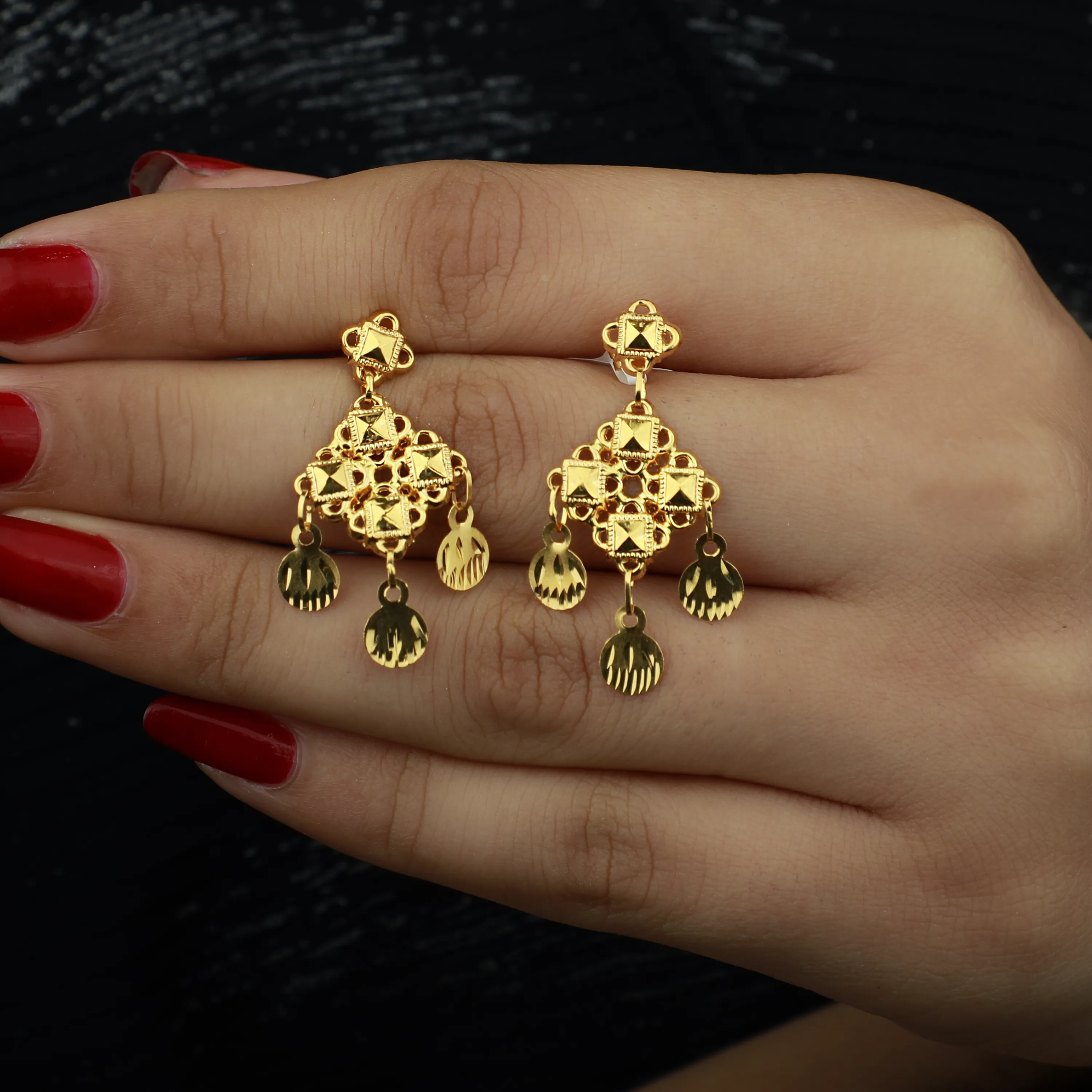 21-karat gold earrings, made in Singapore